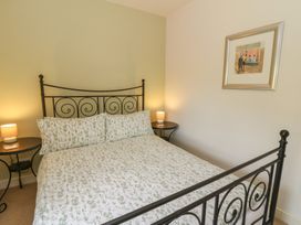A bedroom with a bed and bedside tables at St John's House in Newport, Pembrokeshire