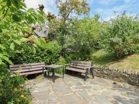 A garden with benches and a table at St John's House in Newport, Pembrokeshire