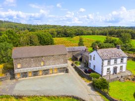 A house and barn with gravel driveway and fields at Grove House in Grange-Over-Sands