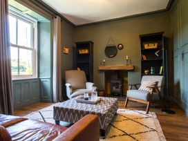 A living room with a window and a coffee table at Grove House in Grange-Over-Sands