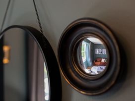 A living room observed through a decorative mirror at Grove House in Grange-Over-Sands