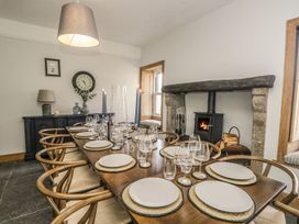 A dining room with a table set for a meal at Grove House in Grange-Over-Sands