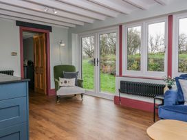 A living room with an armchair and sofa at Grove House in Grange-Over-Sands