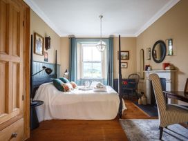 A bedroom with a bed and fireplace at Grove House in Grange-Over-Sands