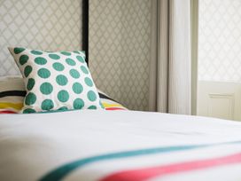 A bed with a pillow in a bedroom at Grove House in Grange-Over-Sands