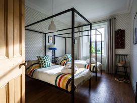A bedroom with two beds and a window at Grove House in Grange-Over-Sands