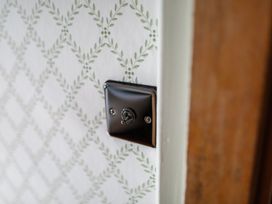 A light switch on a patterned wall at Grove House in Grange-Over-Sands
