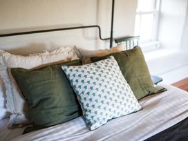 A bed with pillows in a bedroom at Grove House in Grange-Over-Sands
