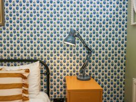A bedroom with a bed and lamp at Grove House in Grange-Over-Sands