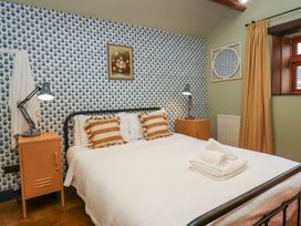 A bedroom with a bed and bedside table at Grove House in Grange-Over-Sands