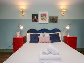 A bedroom with a bed and nightstands at Grove House in Grange-Over-Sands