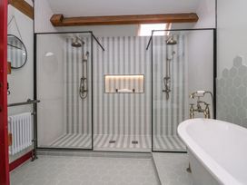 A bathroom with a shower and bathtub at Grove House in Grange-Over-Sands