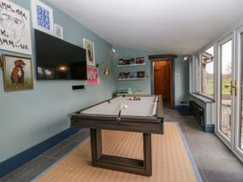 A games room with a pool table and television at Grove House in Grange-Over-Sands