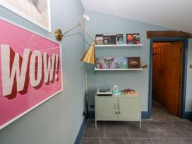 A corridor with a turntable and vinyl records at Grove House in Grange-Over-Sands