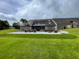 A house with a patio and outdoor furniture at Grove House in Grange-Over-Sands