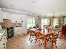 A kitchen with a dining table and chairs at The Lodge in Gorey, County Wexford