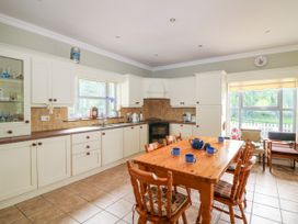A kitchen with a table and chairs at The Lodge in Gorey, County Wexford