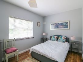 A bedroom with a bed and bedside tables at The Lodge in Gorey, County Wexford