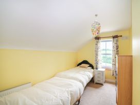 A bedroom with two beds and a window at The Lodge in Gorey, County Wexford
