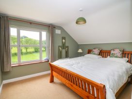 A bedroom with a bed and window at The Lodge in Gorey, County Wexford