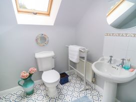 A bathroom with a sink toilet and towel rack at The Lodge in Gorey, County Wexford