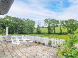 An outdoor patio with a table and chairs at The Lodge in Gorey, County Wexford
