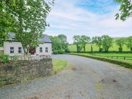A house with gravel driveway surrounded by trees at The Lodge in Gorey, County Wexford