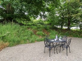 A table and chairs in an outdoor area at Gwybedog in Llanwrda
