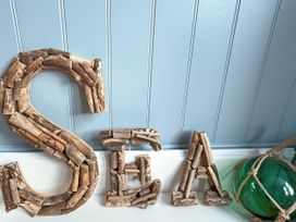 Wooden letters spelling SEA and a glass buoy at 21 Station Hill