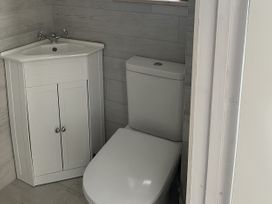A bathroom with a vanity sink and toilet at 21 Station Hill 