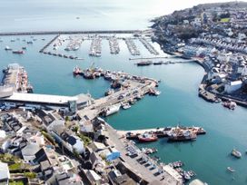 An aerial view of a harbor with boats and surrounding buildings at 21 Station Hill
