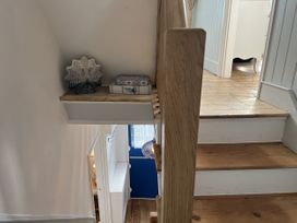 A staircase with a decorative bowl and box at Still Waters in Brixham