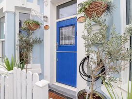An entryway with a blue door and potted plants at Still Waters in Brixham