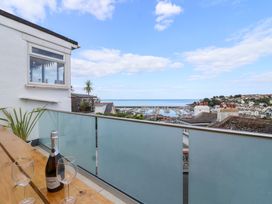 A balcony with a view of the sea and marina at Still Waters in Brixham