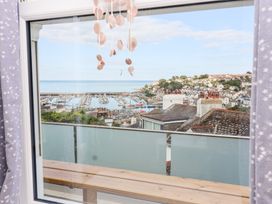 A view from a window overlooking a marina and coastal houses at Still Waters in Brixham
