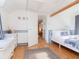 A bedroom with a bed and dresser at Still Waters in Brixham