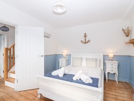 A bedroom with a bed and nightstands at Still Waters in Brixham
