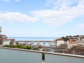A view of a marina and sea from a balcony at Still Waters in Brixham