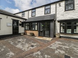 An outdoor entrance area with a path and planters at Penny Farthing Inn Aston Crews near Ross-On-Wye