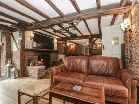 A snug area with a sofa and fireplace at Penny Farthing Inn Aston Crews near Ross-On-Wye