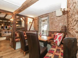 A dining room with a table and chairs at Penny Farthing Inn in Aston Crews near Ross-On-Wye