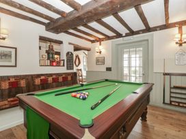 A games room with a pool table and bench seating at Penny Farthing Inn Aston Crews near Ross-On-Wye