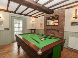 A games room with a pool table and a fireplace at Penny Farthing Inn Aston Crews near Ross-On-Wye