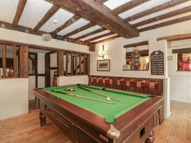 A snug room with a pool table and framed pictures at Penny Farthing Inn Aston Crews near Ross-On-Wye