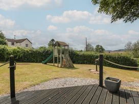 A garden with a playground and slide at Penny Farthing Inn Aston Crews near Ross-On-Wye