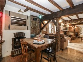 A dining room with a table and chairs at Penny Farthing Inn Aston Crews near Ross-On-Wye