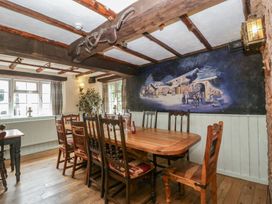 A dining room with a large table and chairs at Penny Farthing Inn Aston Crews near Ross-On-Wye