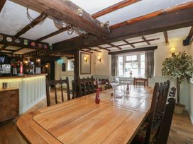 A dining room with a large table and chairs at Penny Farthing Inn Aston Crews near Ross-On-Wye