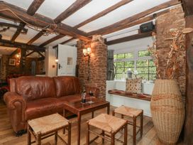 A living room with a leather sofa and a coffee table at Penny Farthing Inn Aston Crews near Ross-On-Wye