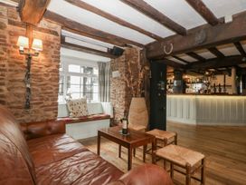 A bar area with a sofa and a table at Penny Farthing Inn Aston Crews near Ross-On-Wye